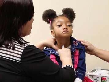 Supporting a child while replacing a tracheostomy