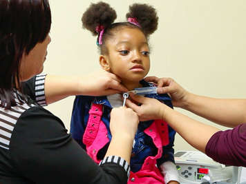 Supporting a child’s tracheostomy tube while removing the obturator