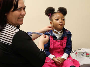 Caregiver and child with a tracheostomy.