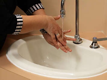 Caregiver washing their hands.