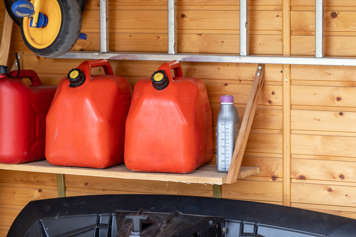 Cans of gasoline on a shelf