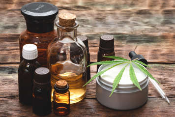 Bottles and cream with cannabis leaf on top