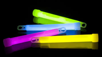Colourful glow sticks on dark background