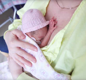 An infant receiving kangaroo care