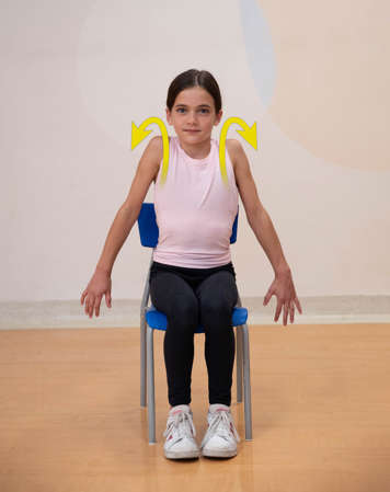 girl sitting in chair rolling shoulders backward