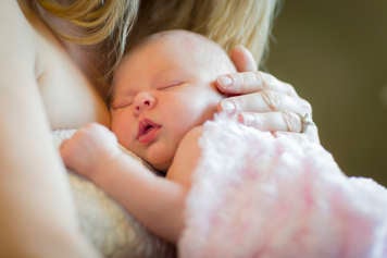 Mother holding baby against her chest