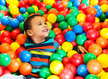 Boy playing in ball pit