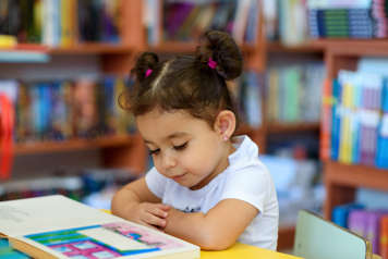 Girl sitting and reading a book