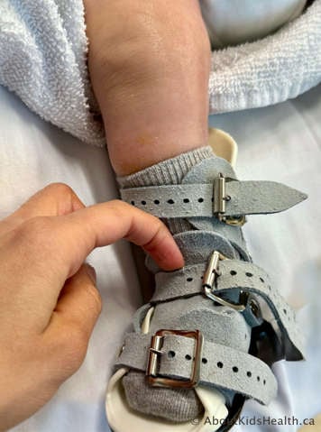 Caregiver checking they can fit a fingernail under the strap