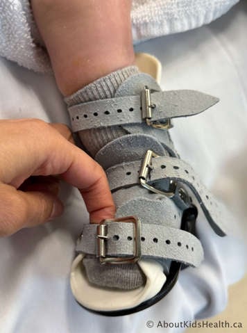 Checking the bottom strap to make sure you can fit a finger underneath