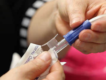 Attaching suction tubing to a tracheostomy suction catheter