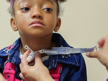 Removing tracheostomy tube ties.