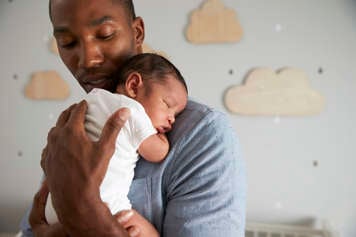 Father carrying baby on his chest